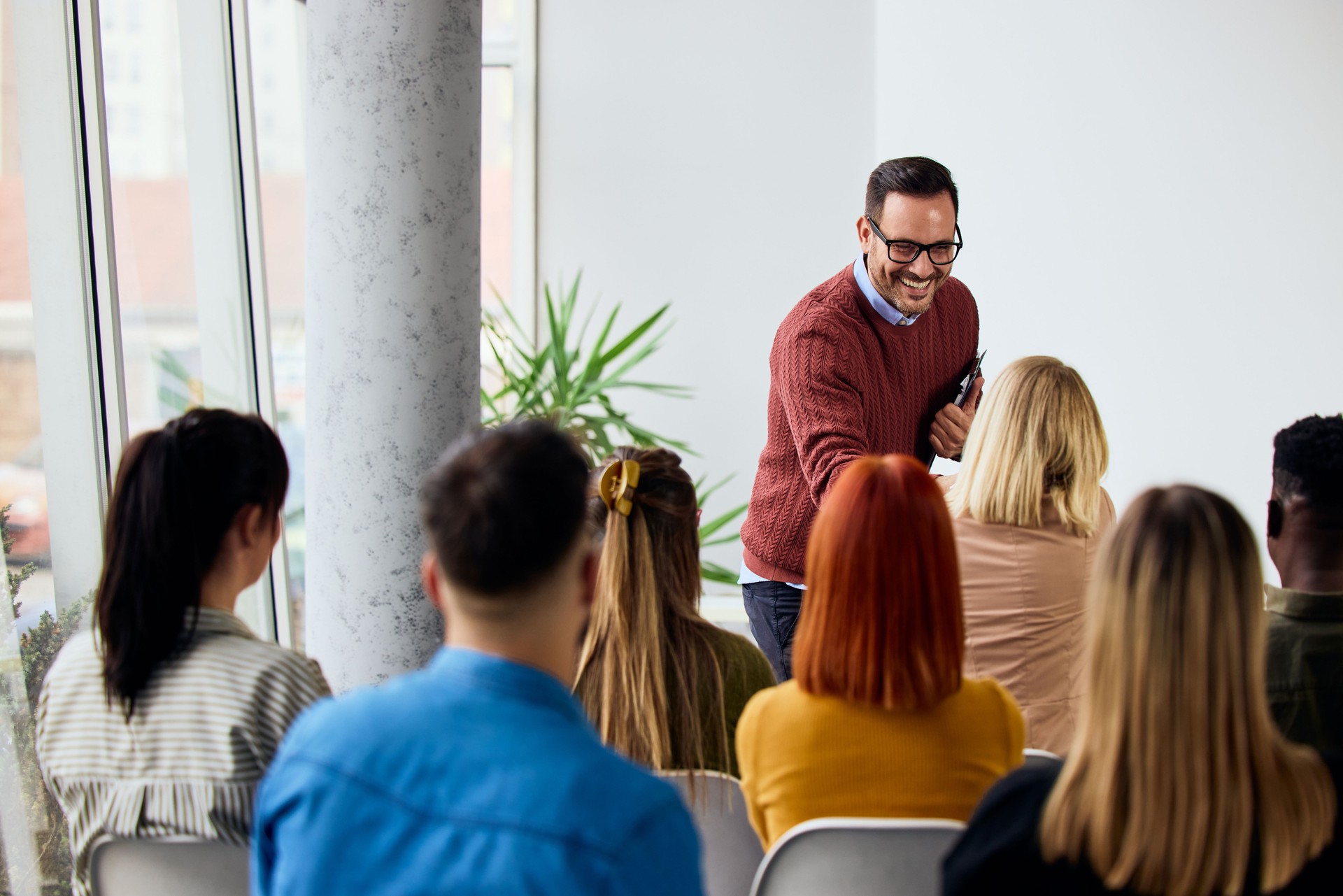 Smiling Presenter Engaging With Audience During an Interactive Workshop Session